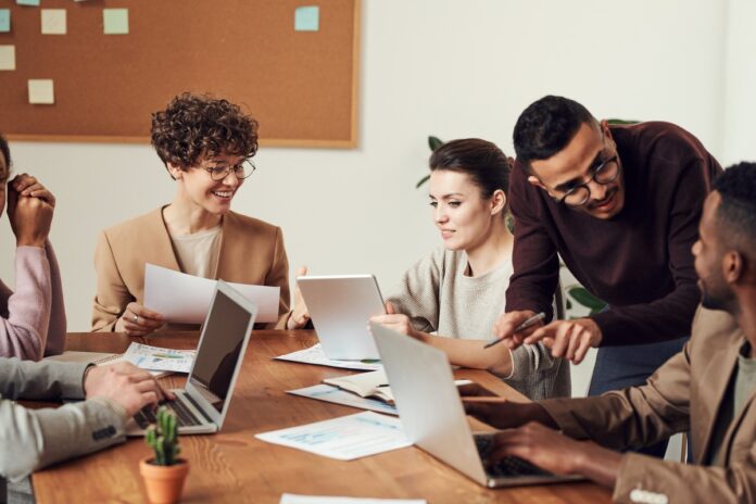 a group of office workers discussing work in the cannabis industry