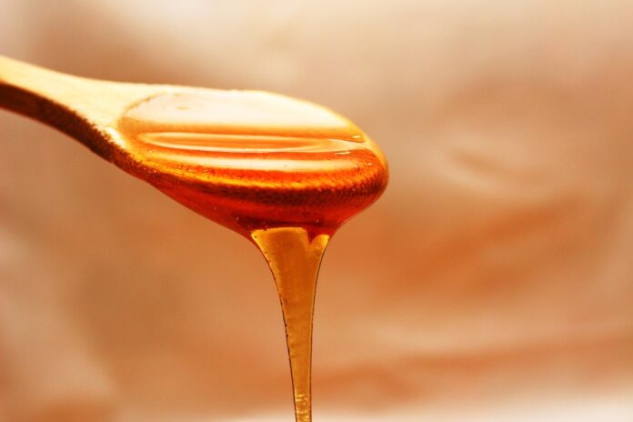a honey on a wooden spoon